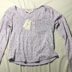 A purple long sleeve shirt with pink and white roses size small